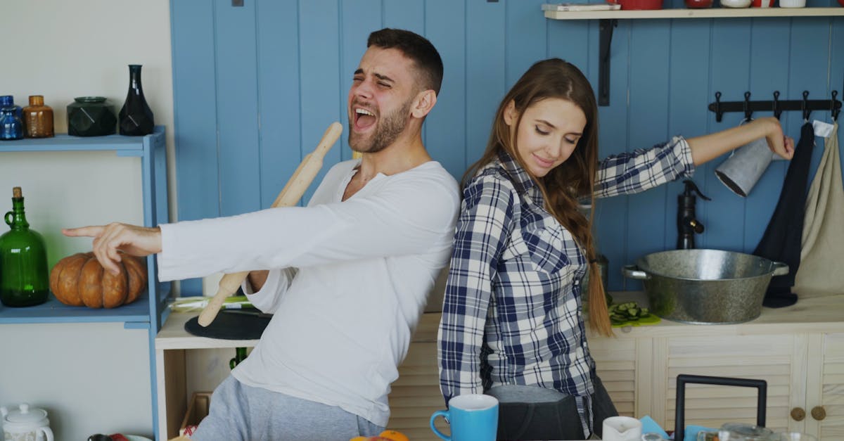 A casual cooking class scene with a Korean couple in their 40s making pasta together, small kitchen studio setting, flour on apron, cheerful atmosphere, natural indoor lighting